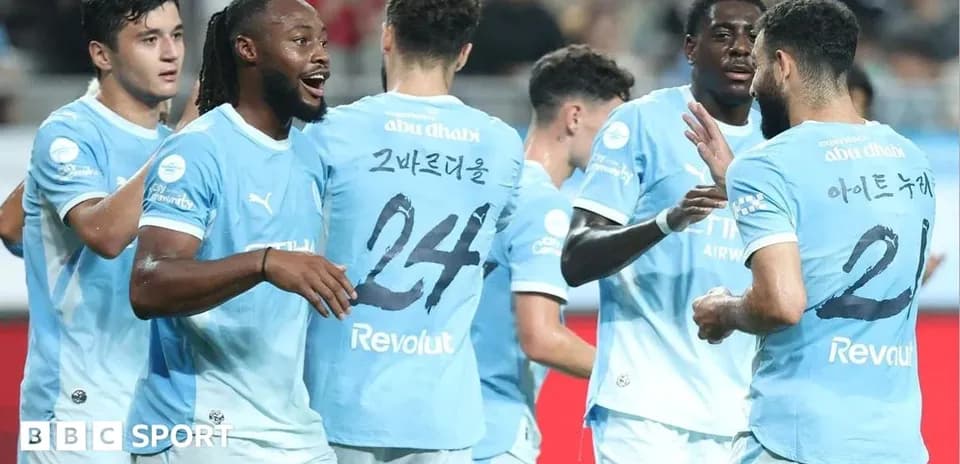 Players celebrating a goal in light blue jerseys