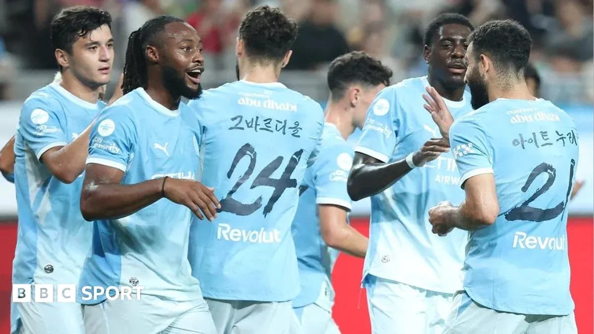 Players celebrating a goal in light blue jerseys