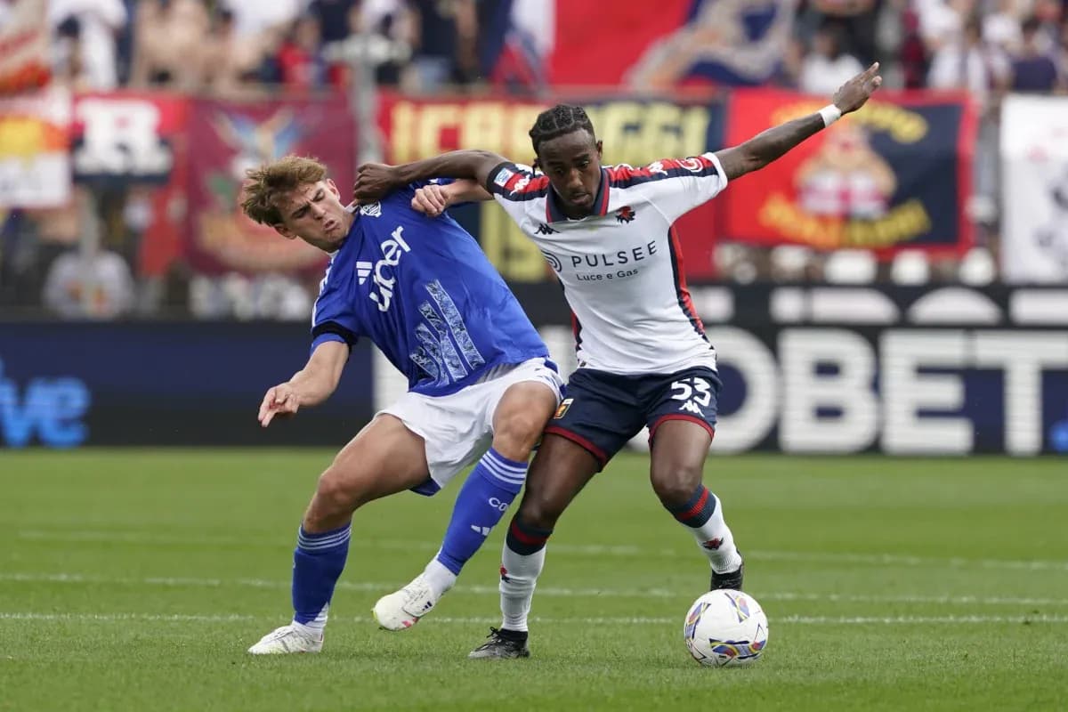 Genoa player tackling Como opponent during match