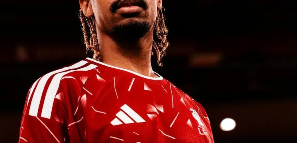 Player in red jersey posing confidently for photo
