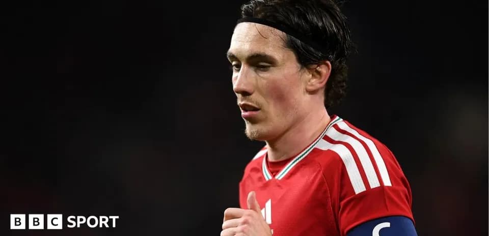Player wearing red jersey with captain's armband
