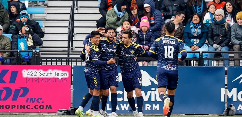 Players celebrating a goal during USL match
