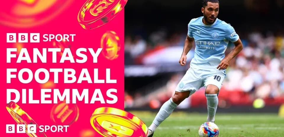 Player in light blue kit dribbling on football pitch