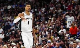 Player gesturing during game with fans in background