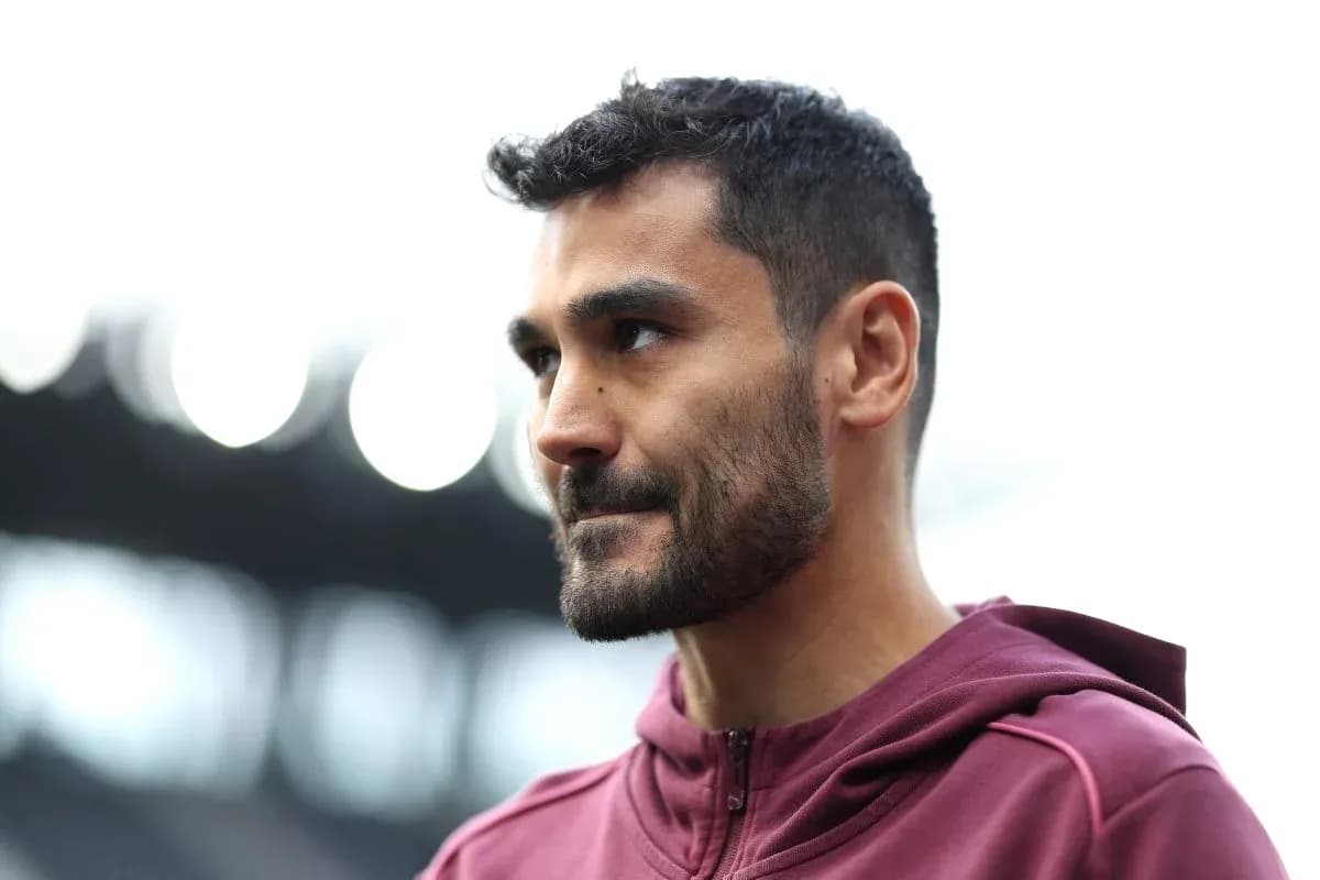 Player in maroon hoodie during match preparation