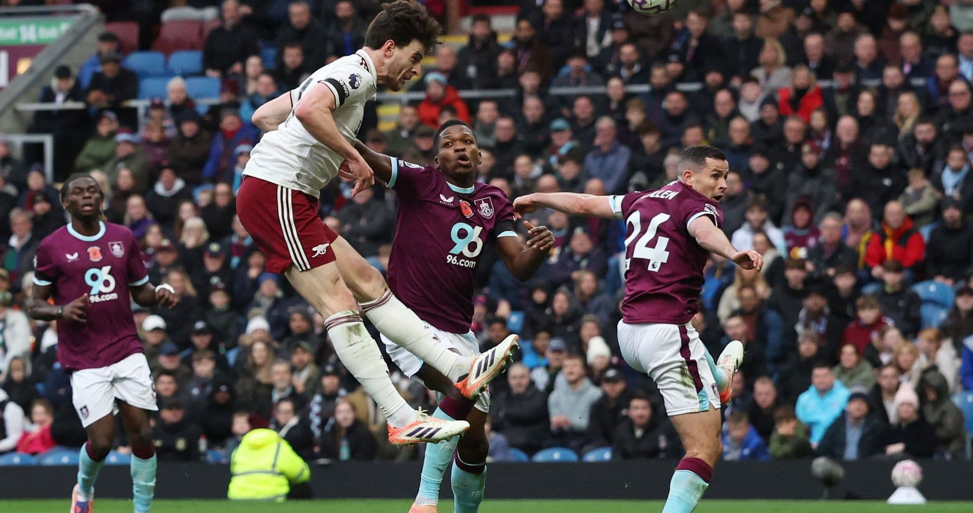 Arsenal player attempting a header during match
