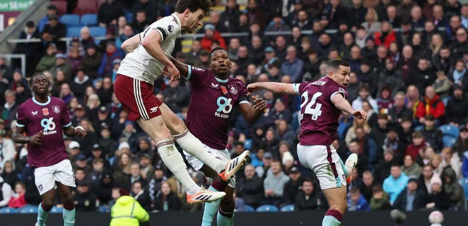 Arsenal player attempting a header during match