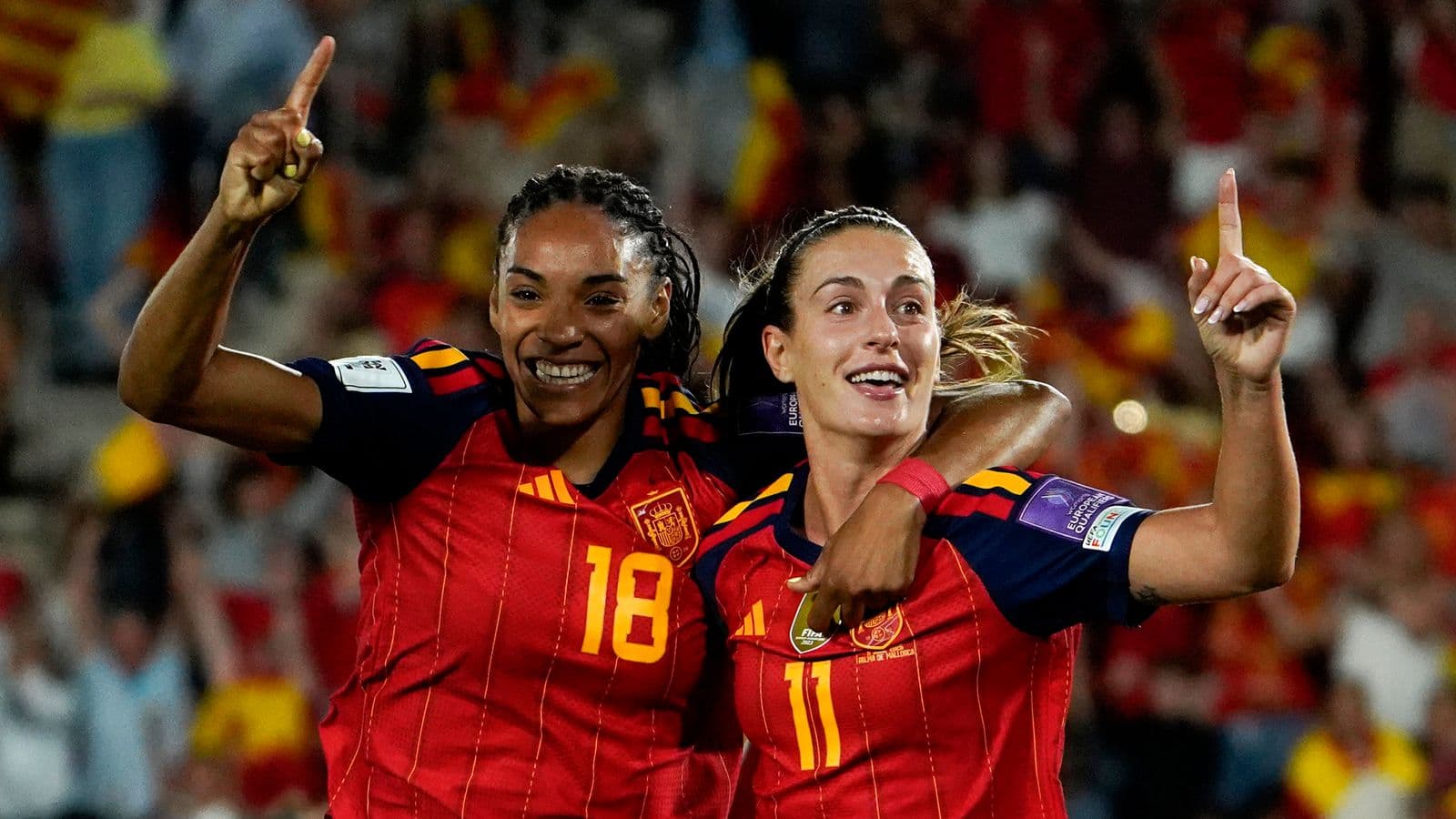 Two Spanish players celebrating a goal during match