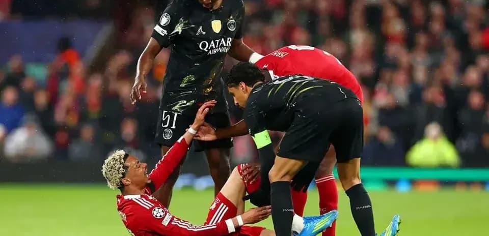 Players assisting an injured teammate on the field