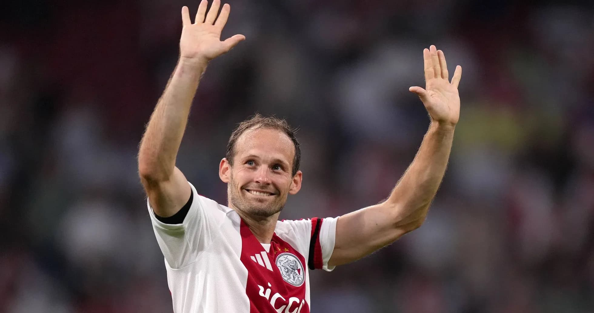 Player waving to fans in Ajax jersey
