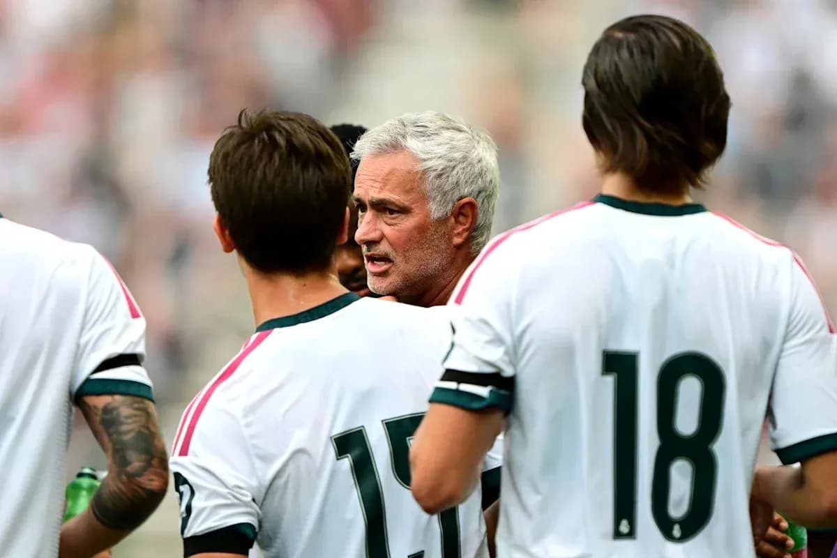 Coach discussing strategy with players on the field
