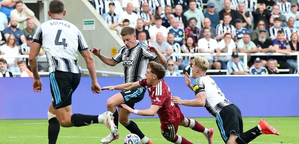 Players contesting the ball during a football match