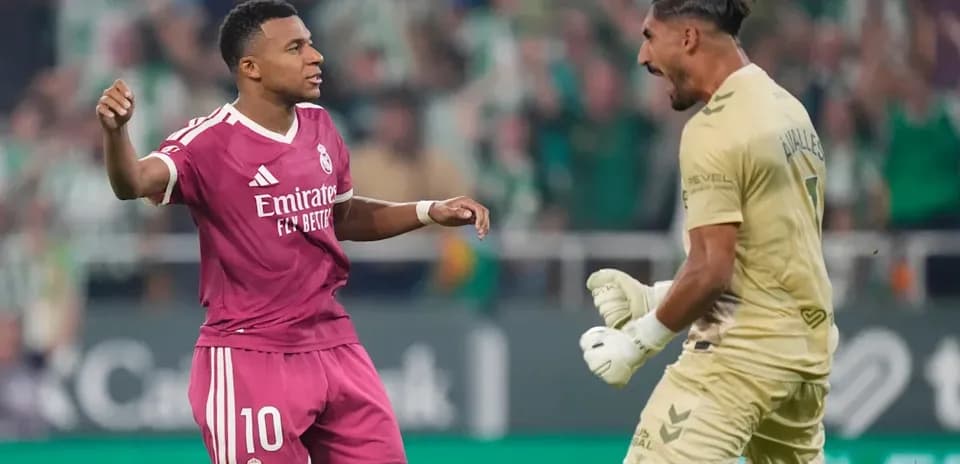 Player celebrating after scoring against the goalkeeper
