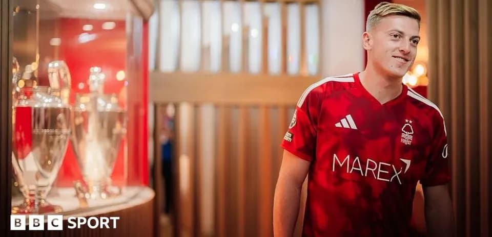 Player in Nottingham Forest jersey next to trophies
