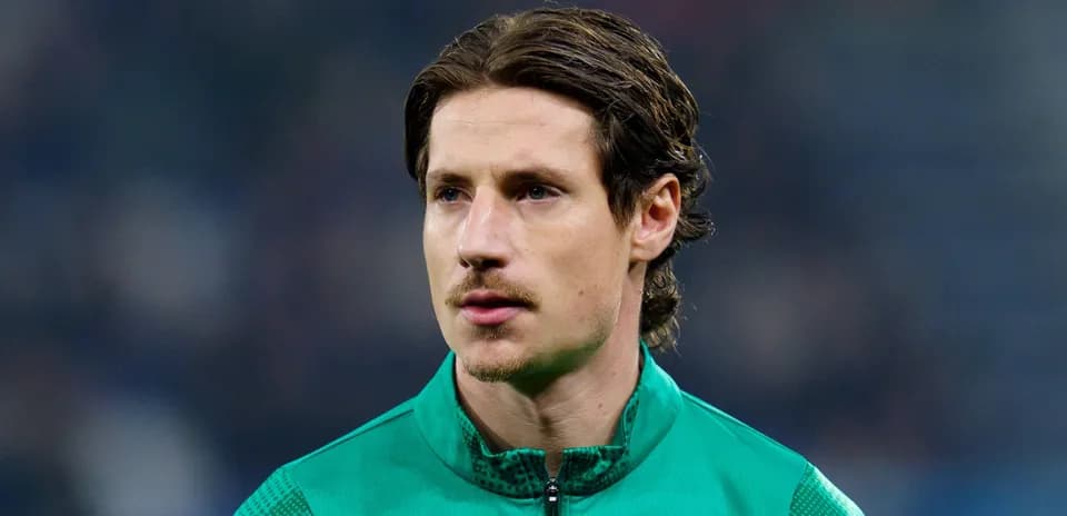 Goalkeeper in green jersey during warm-up
