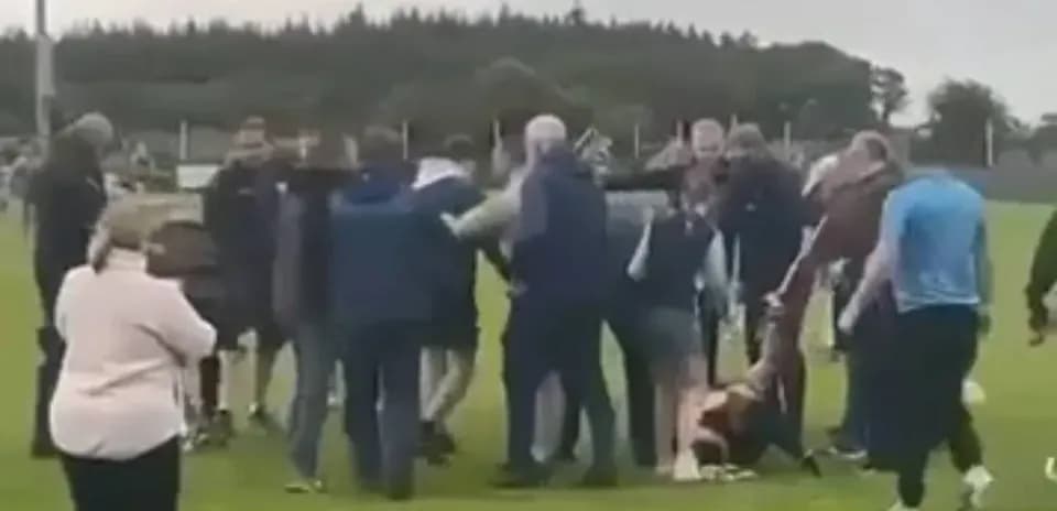 Group of people gathered on a sports field