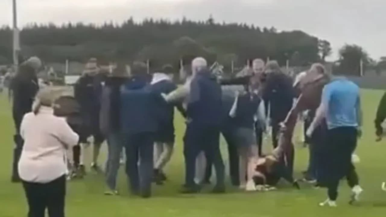 Group of people gathered on a sports field