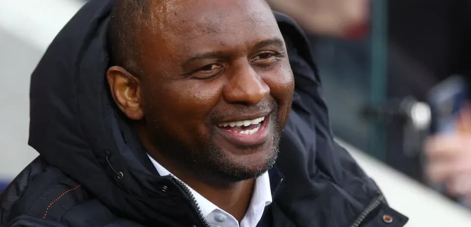 Man smiling while seated in the stands