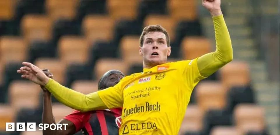 Player in yellow jersey competing for a header
