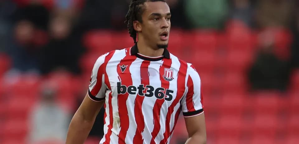 Player in Stoke City jersey on the pitch