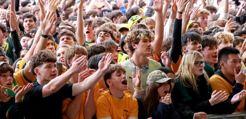 Crowd cheering enthusiastically at sporting event