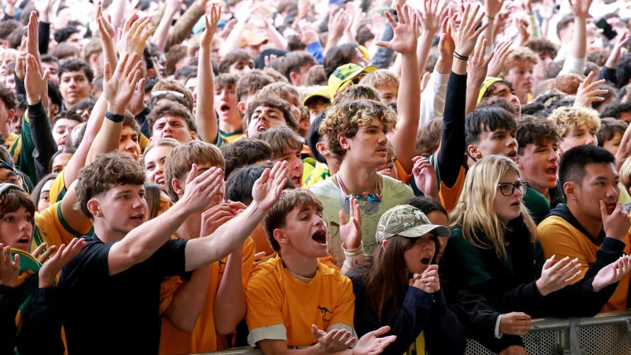 Crowd cheering enthusiastically at sporting event