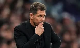 Manager observing the match with pensive expression