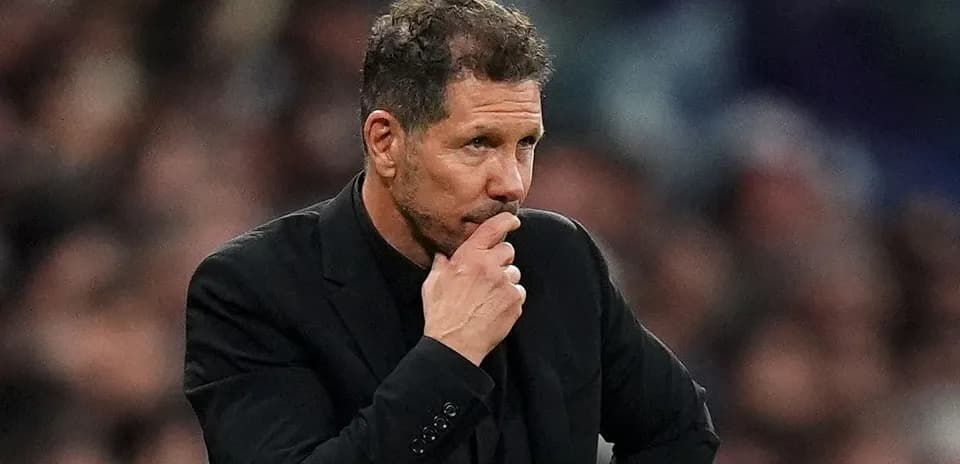 Manager observing the match with pensive expression