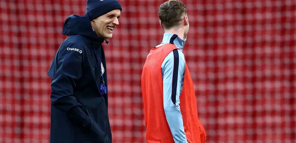 Coach and player laughing during training session