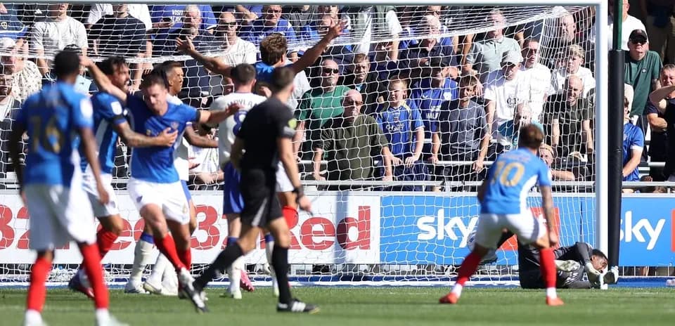 Players reacting after a goal attempt in football match