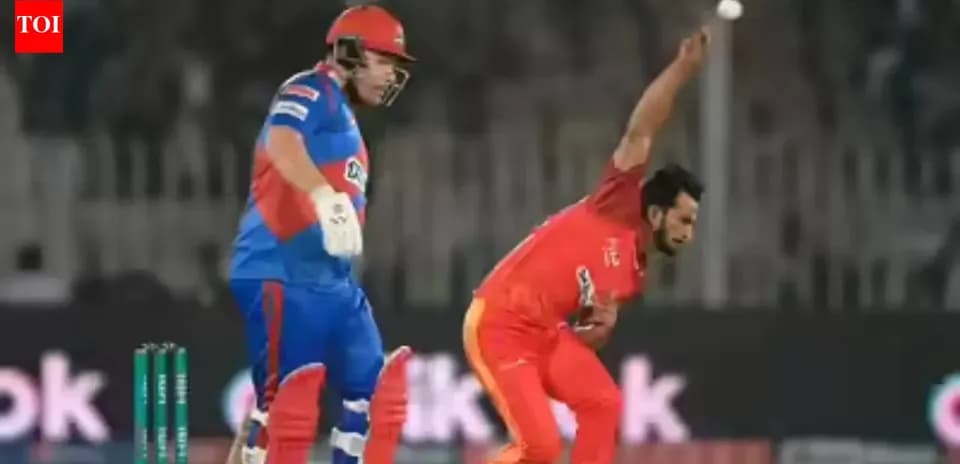 Bowler delivering ball while batsman prepares to hit