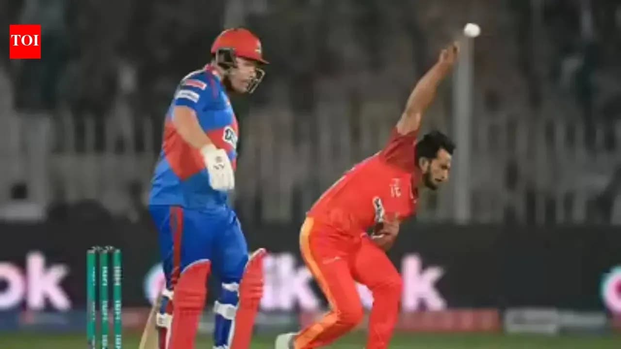 Bowler delivering ball while batsman prepares to hit