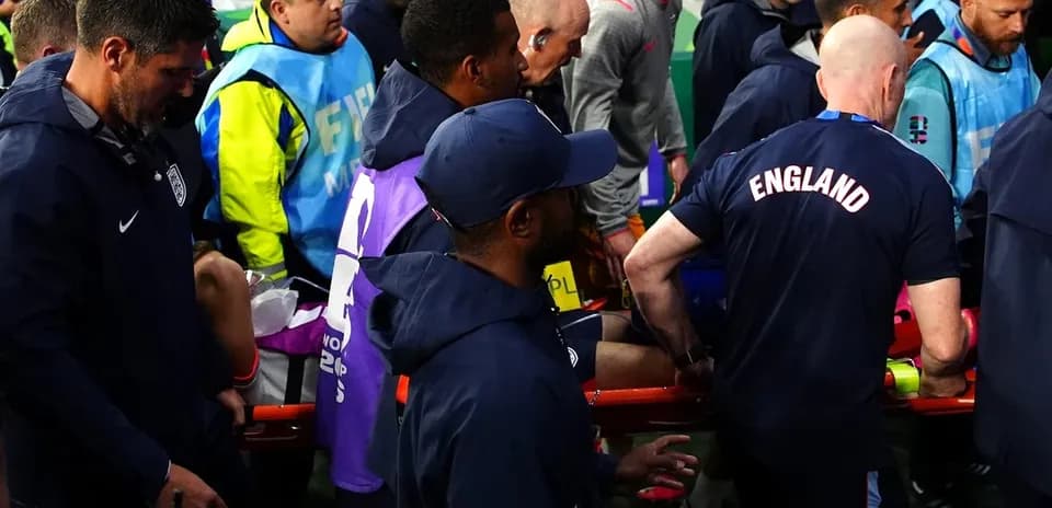 Medical staff attending to player on stretcher
