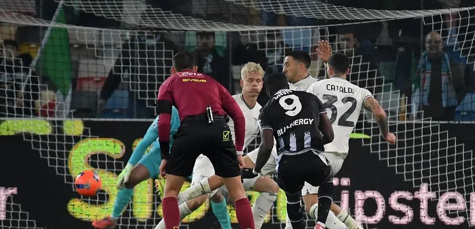 Lazio players defending against Udinese striker