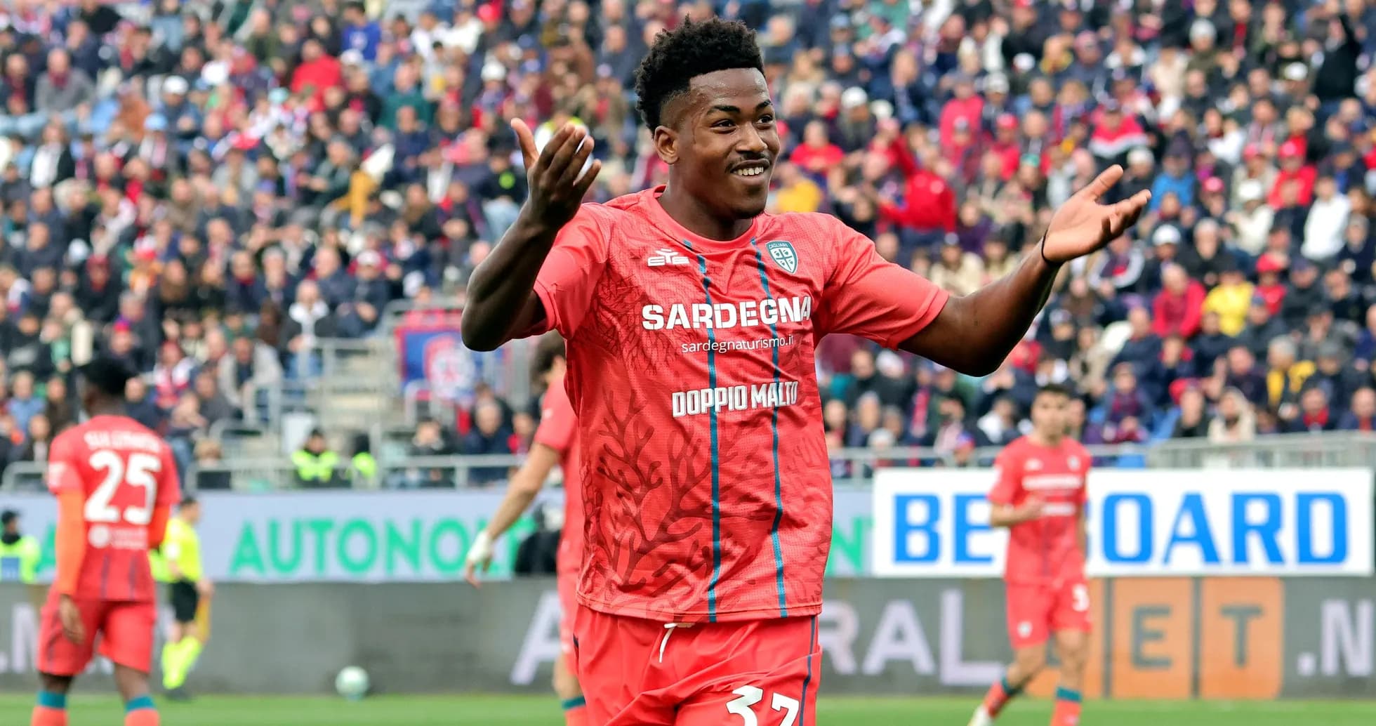 Player celebrating in red jersey during match