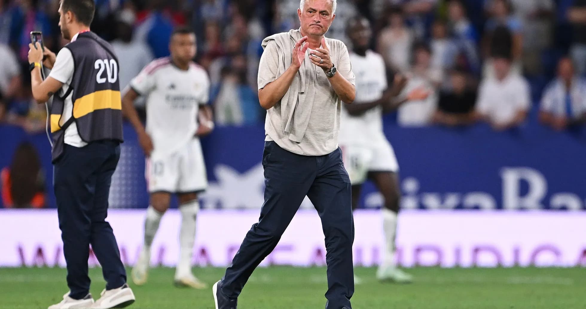 Manager clapping on the sidelines during match