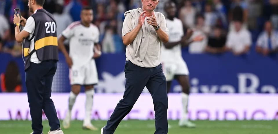 Manager clapping on the sidelines during match