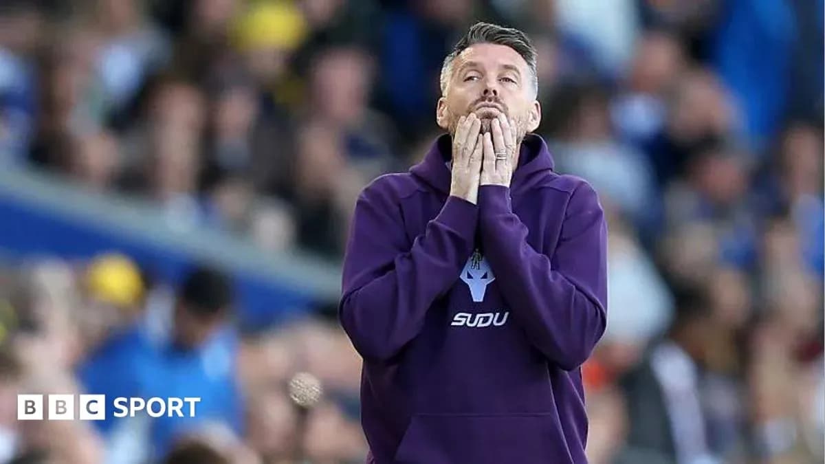 Coach with hands on face during match