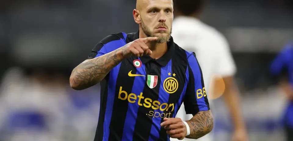 Player in Inter Milan jersey signaling during match