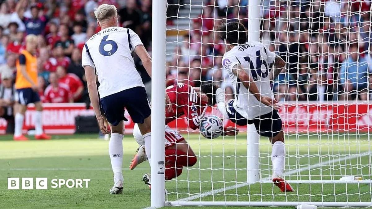 Player attempting to score as goalkeeper dives