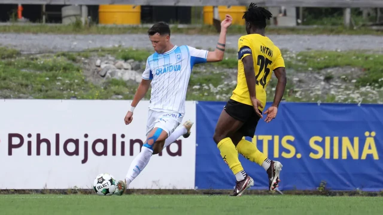 Universitatea Craiova player dribbling past KuPS defender