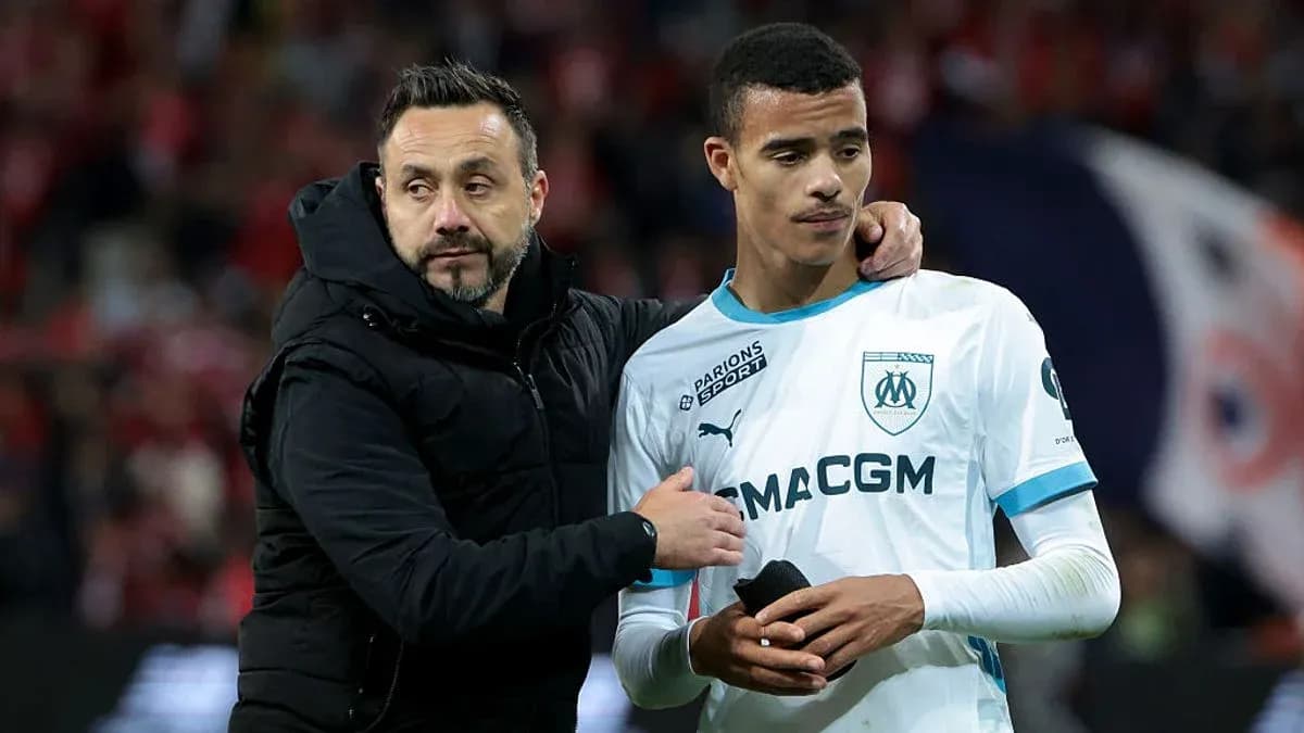 Coach comforting player after match on field