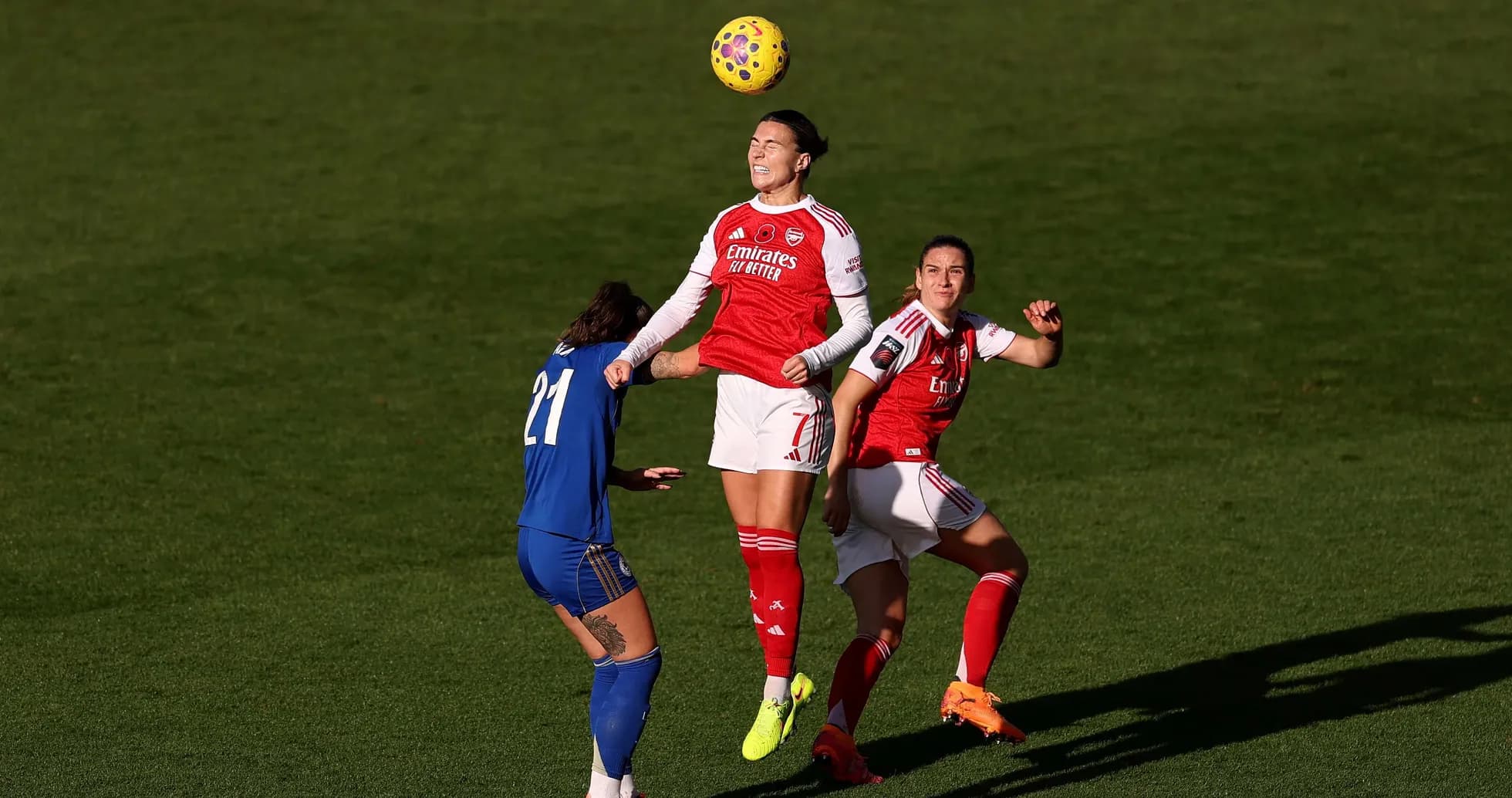 Arsenal player heading the ball during match