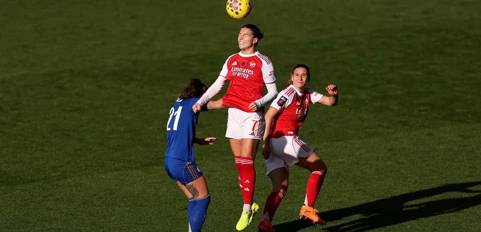 Arsenal player heading the ball during match