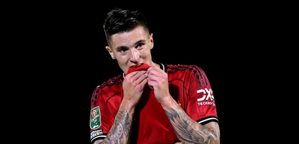 Player biting jersey after match on dark background