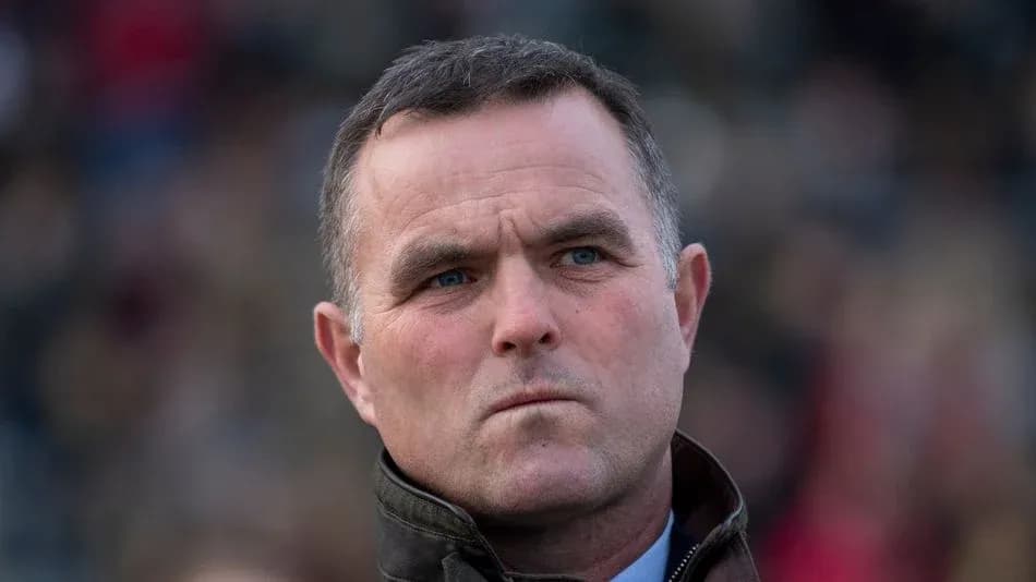 Man in a jacket looking serious outdoors