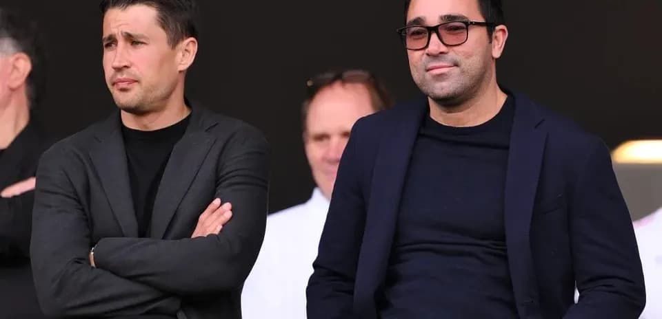 Two men seated in a stadium viewing area