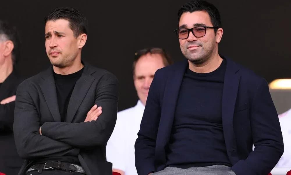 Two men seated in a stadium viewing area