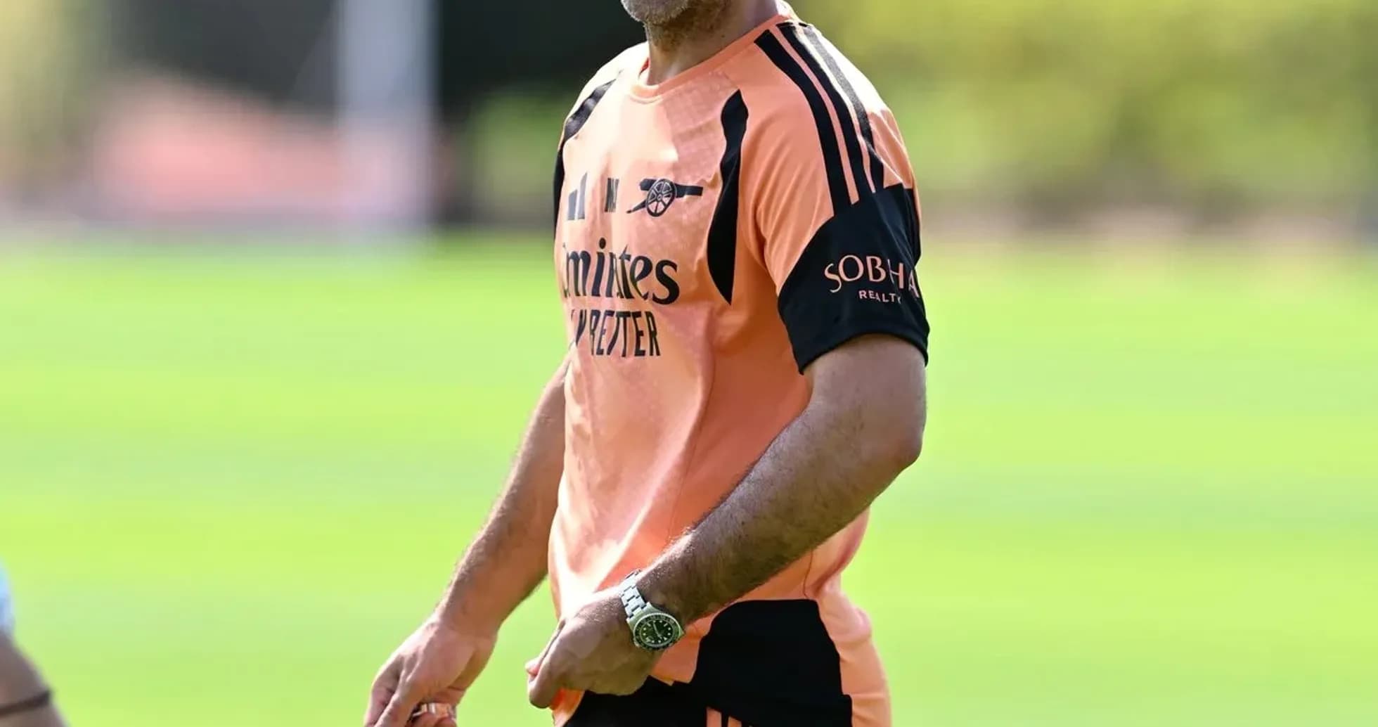 Coach smiling during training session on the pitch