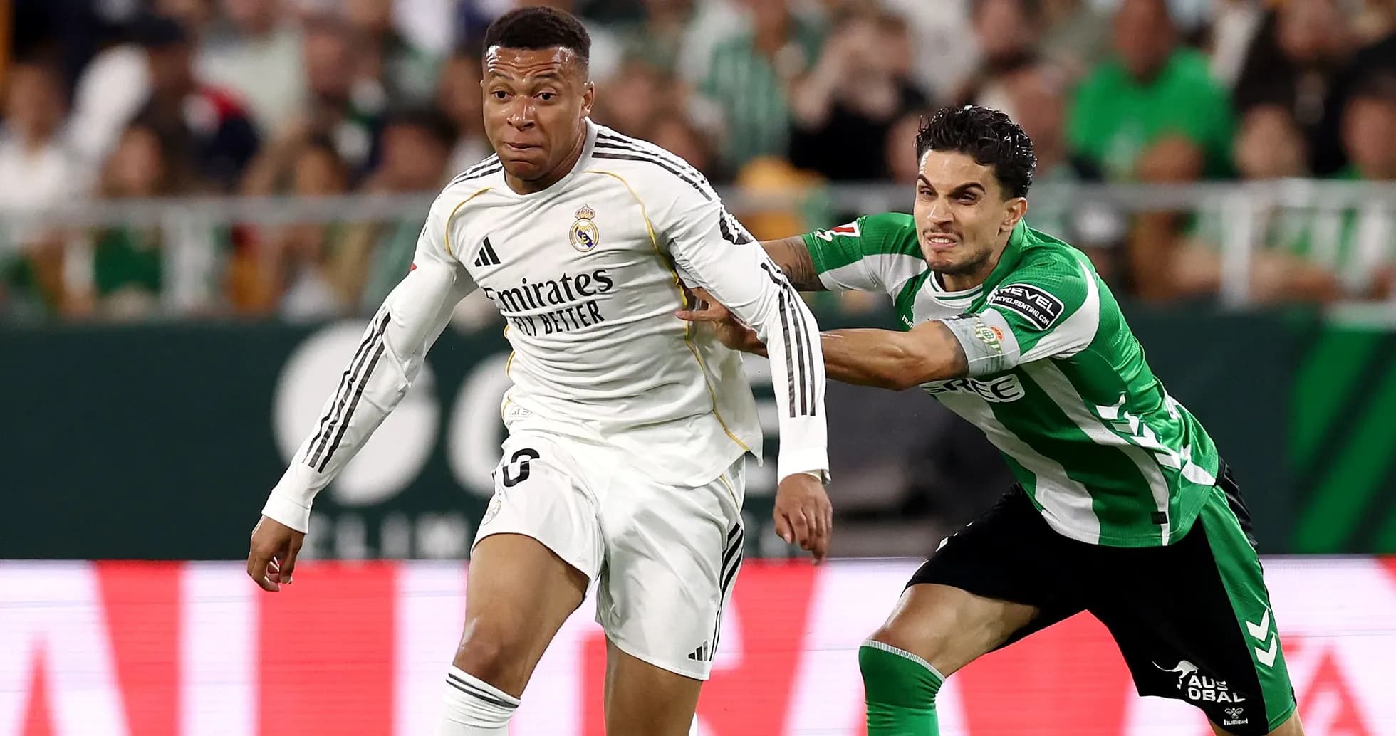 Mbappé dribbling past defender during match